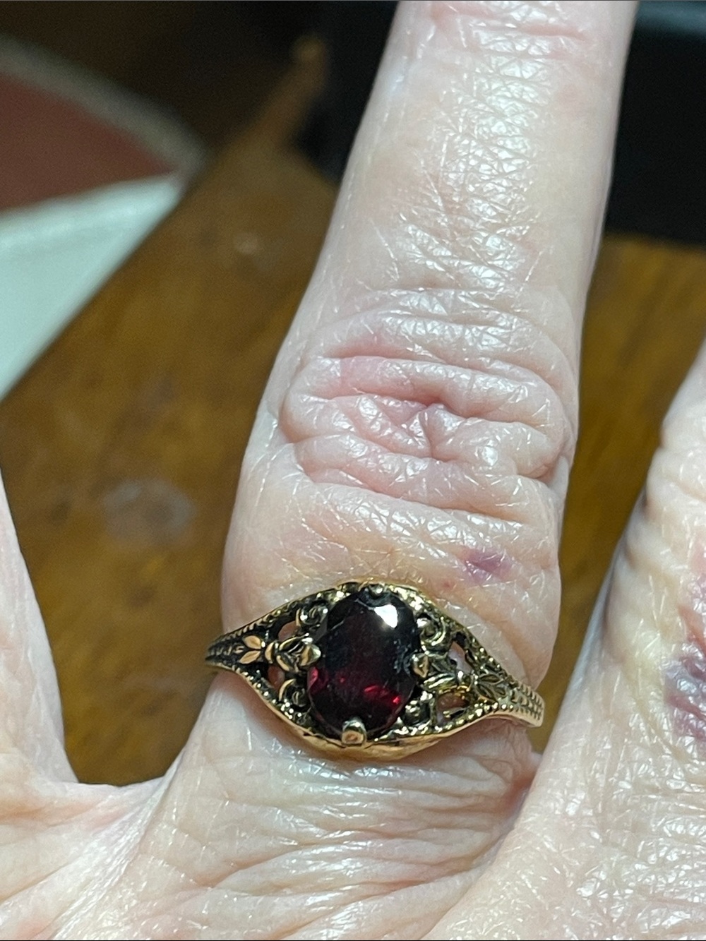 Gold-Tone Filigree Ring with Deep Red Oval Stone